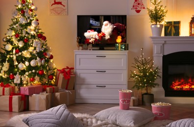 Stylish living room interior with TV set, Christmas tree and fireplace Image of Stylish living room interior with TV set, Christmas tree and fireplace