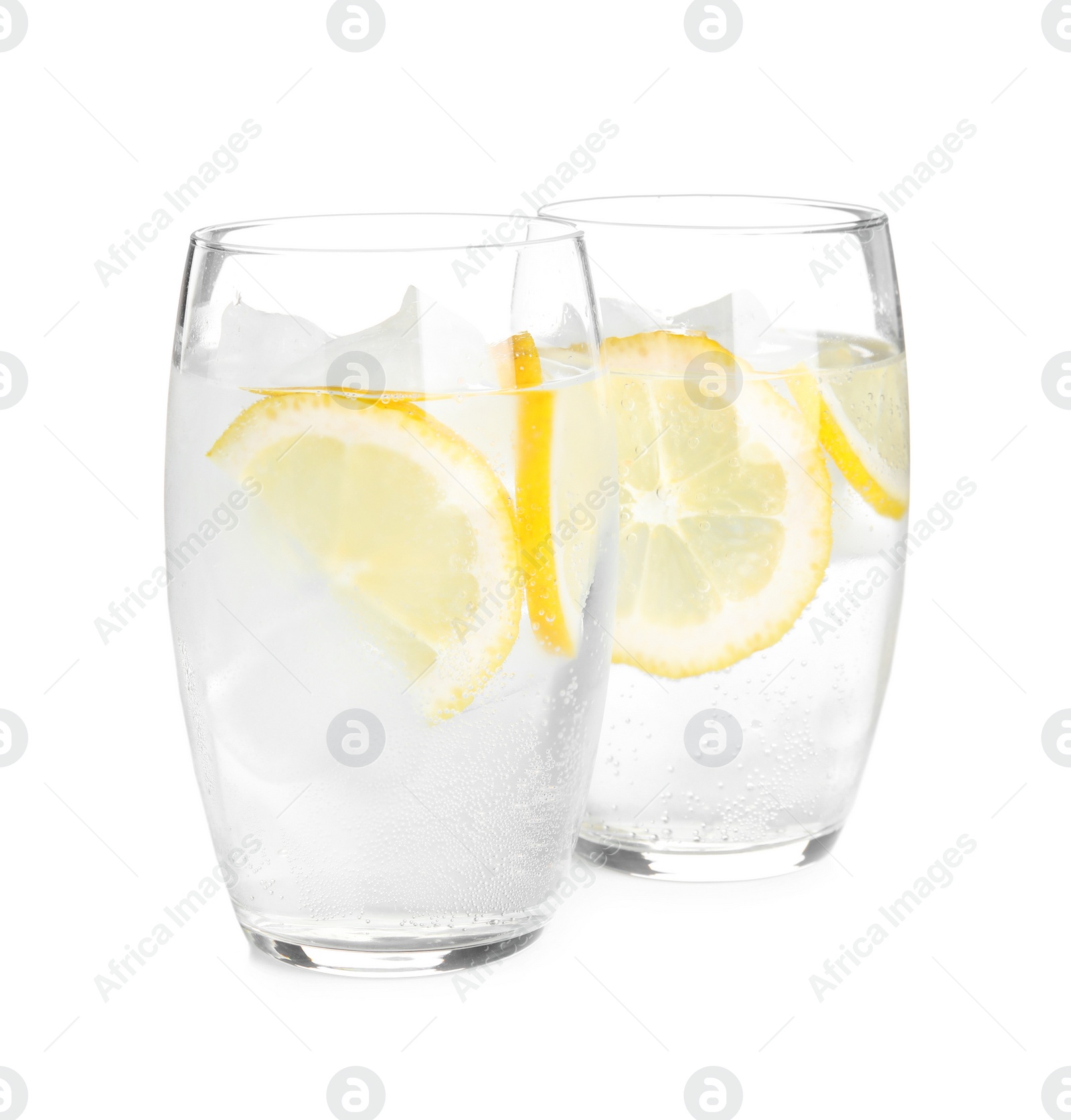 Soda water with lemon slices and ice cubes on white background Photo of Soda water with lemon slices and ice cubes on white background