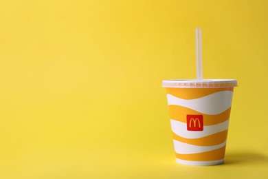 MYKOLAIV, UKRAINE - AUGUST 12, 2021: Cold McDonald's drink on yellow background. Space for text Photo of MYKOLAIV, UKRAINE - AUGUST 12, 2021: Cold McDonald's drink on yellow background. Space for text