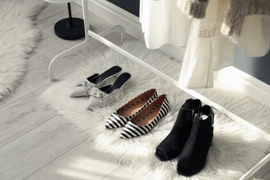 Faux fur rug with stylish women's shoes indoors. Interior design Photo of Faux fur rug with stylish women's shoes indoors. Interior design