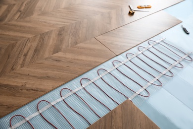 Installation of modern underfloor trace heating system indoors Photo of Installation of modern underfloor trace heating system indoors