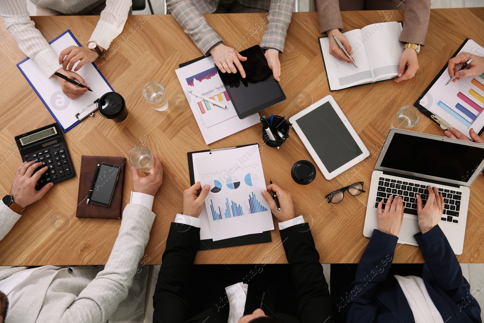 Businesspeople having meeting at table, top view. Management consulting Photo of Businesspeople having meeting at table, top view. Management consulting