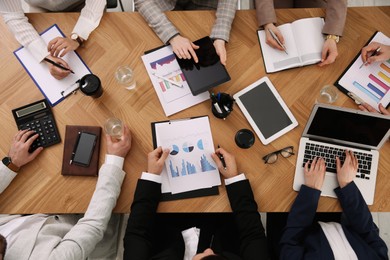 Businesspeople having meeting at table, top view. Management consulting Photo of Businesspeople having meeting at table, top view. Management consulting