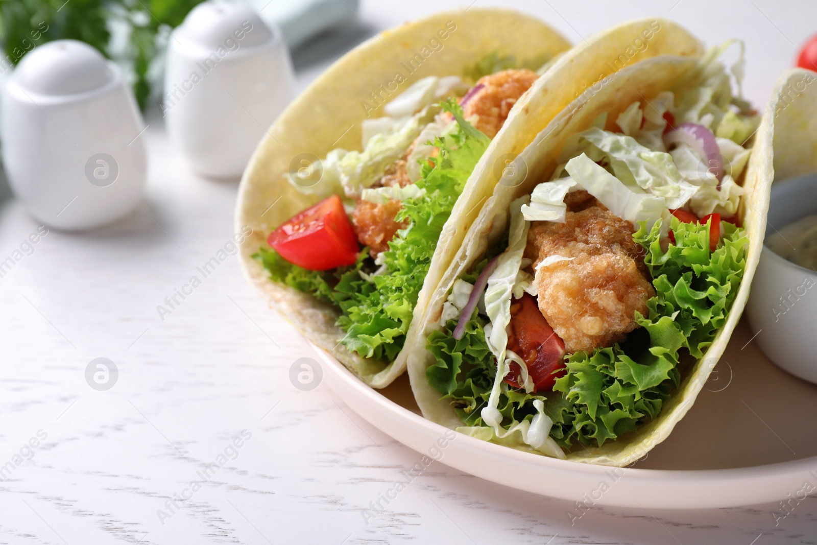 Yummy fish tacos served on white wooden table, closeup Photo of Yummy fish tacos served on white wooden table, closeup
