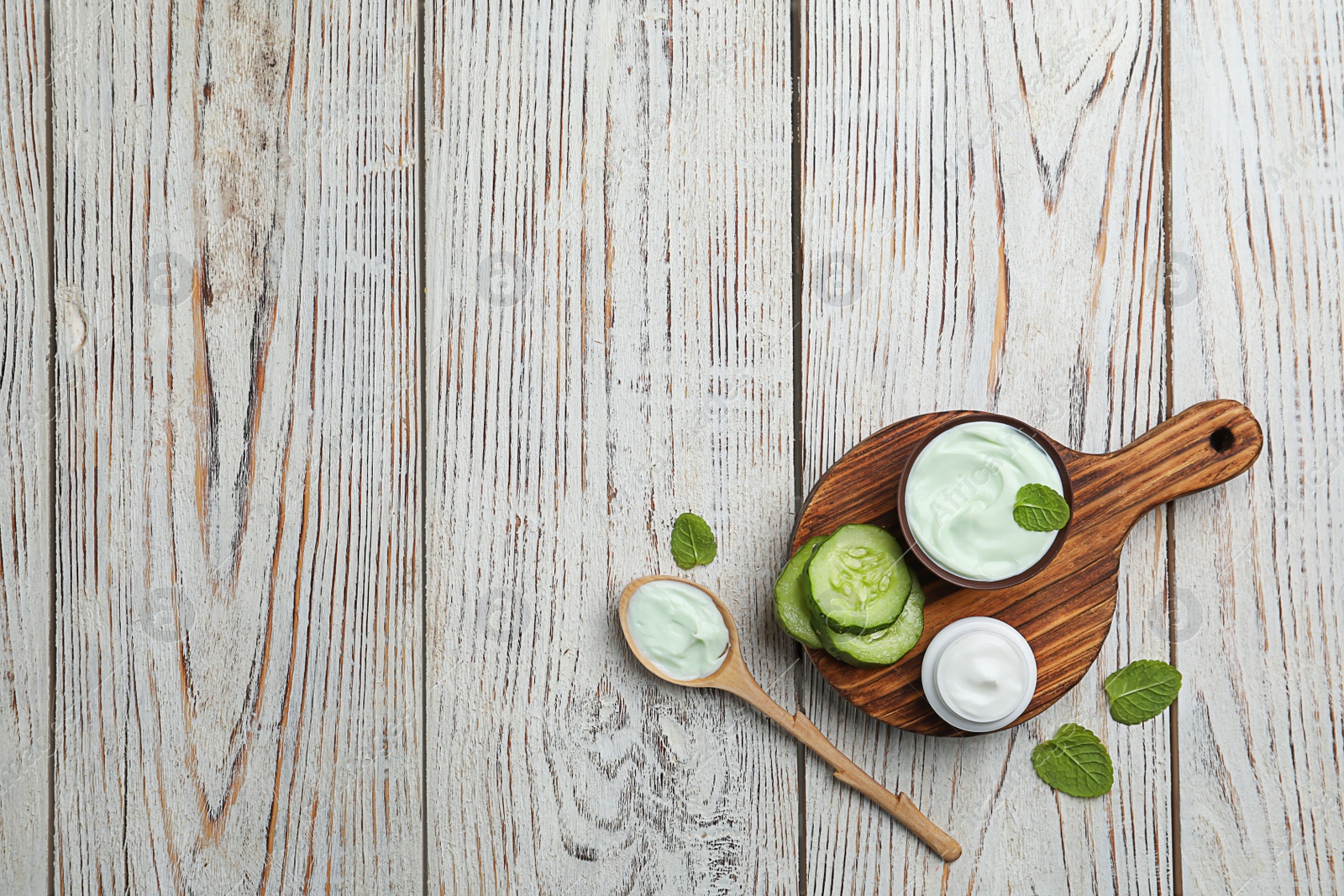 Composition with body cream in jars on wooden background, top view Photo of Composition with body cream in jars on wooden background, top view