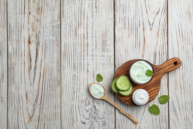 Composition with body cream in jars on wooden background, top view Photo of Composition with body cream in jars on wooden background, top view
