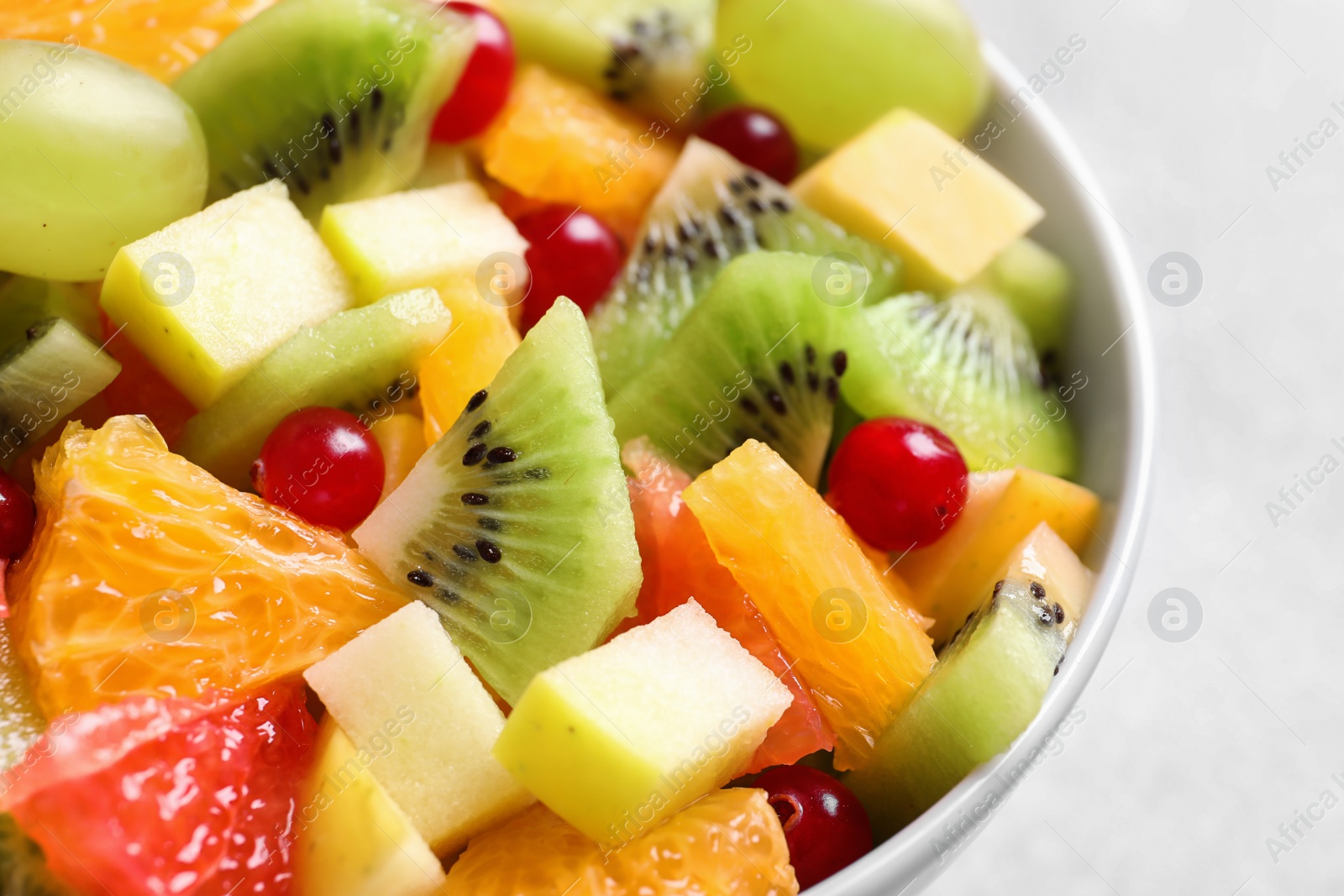 Bowl with fresh fruit salad, closeup Photo of Bowl with fresh fruit salad, closeup
