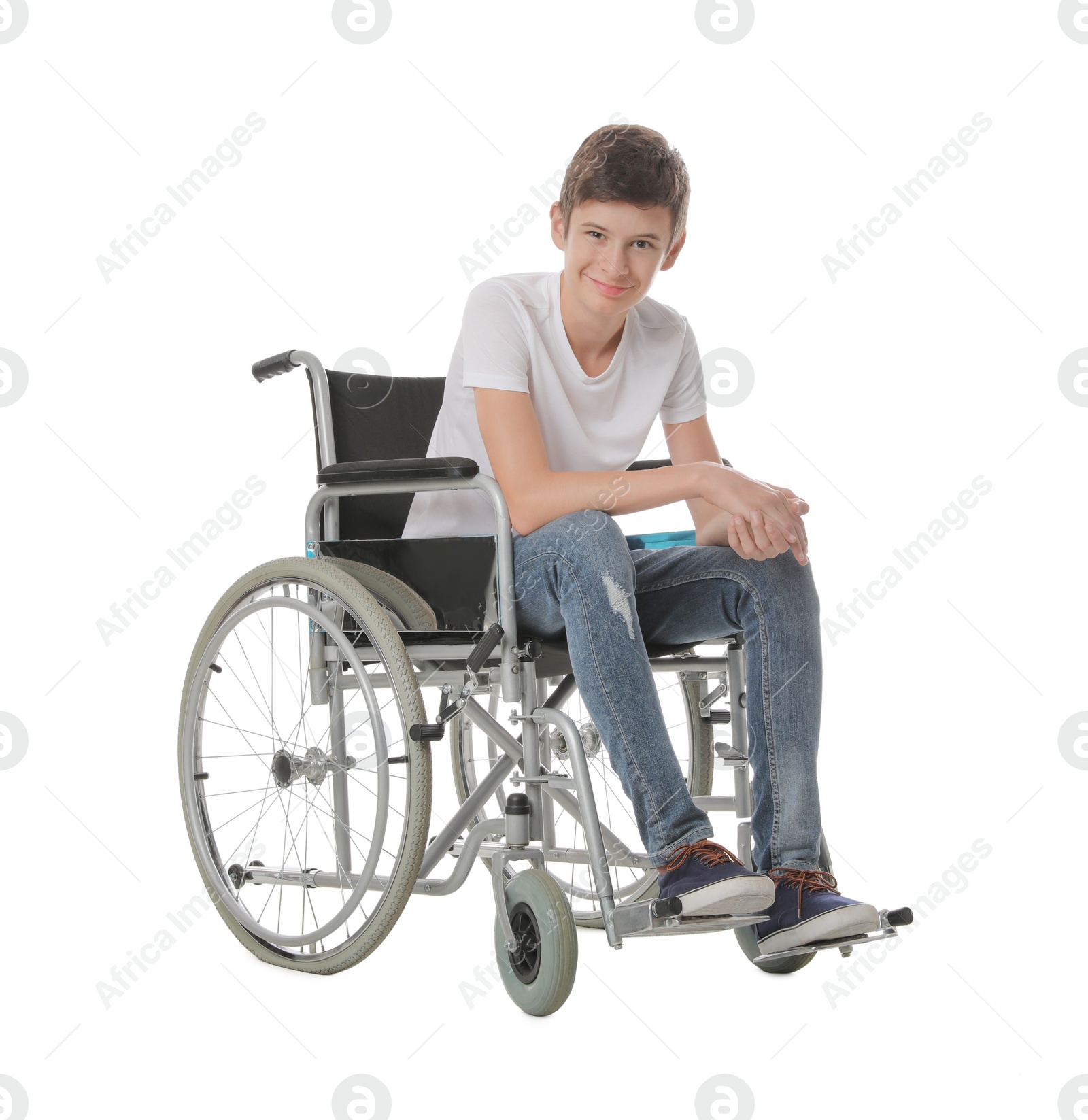 Teen boy in wheelchair on white background Photo of Teen boy in wheelchair on white background