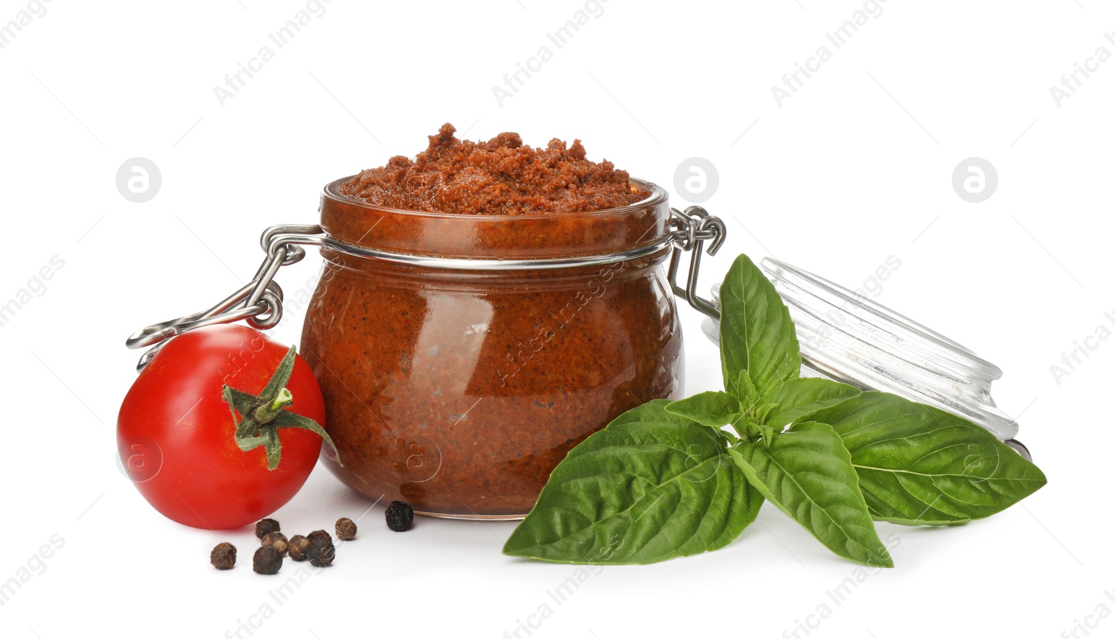 Delicious adjika sauce in glass jar and ingredients isolated on white Photo of Delicious adjika sauce in glass jar and ingredients isolated on white