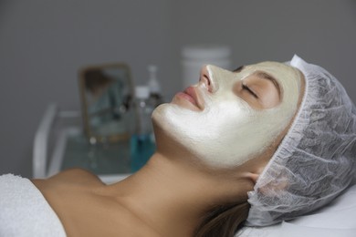 Beautiful woman with mask on her face in spa salon Photo of Beautiful woman with mask on her face in spa salon