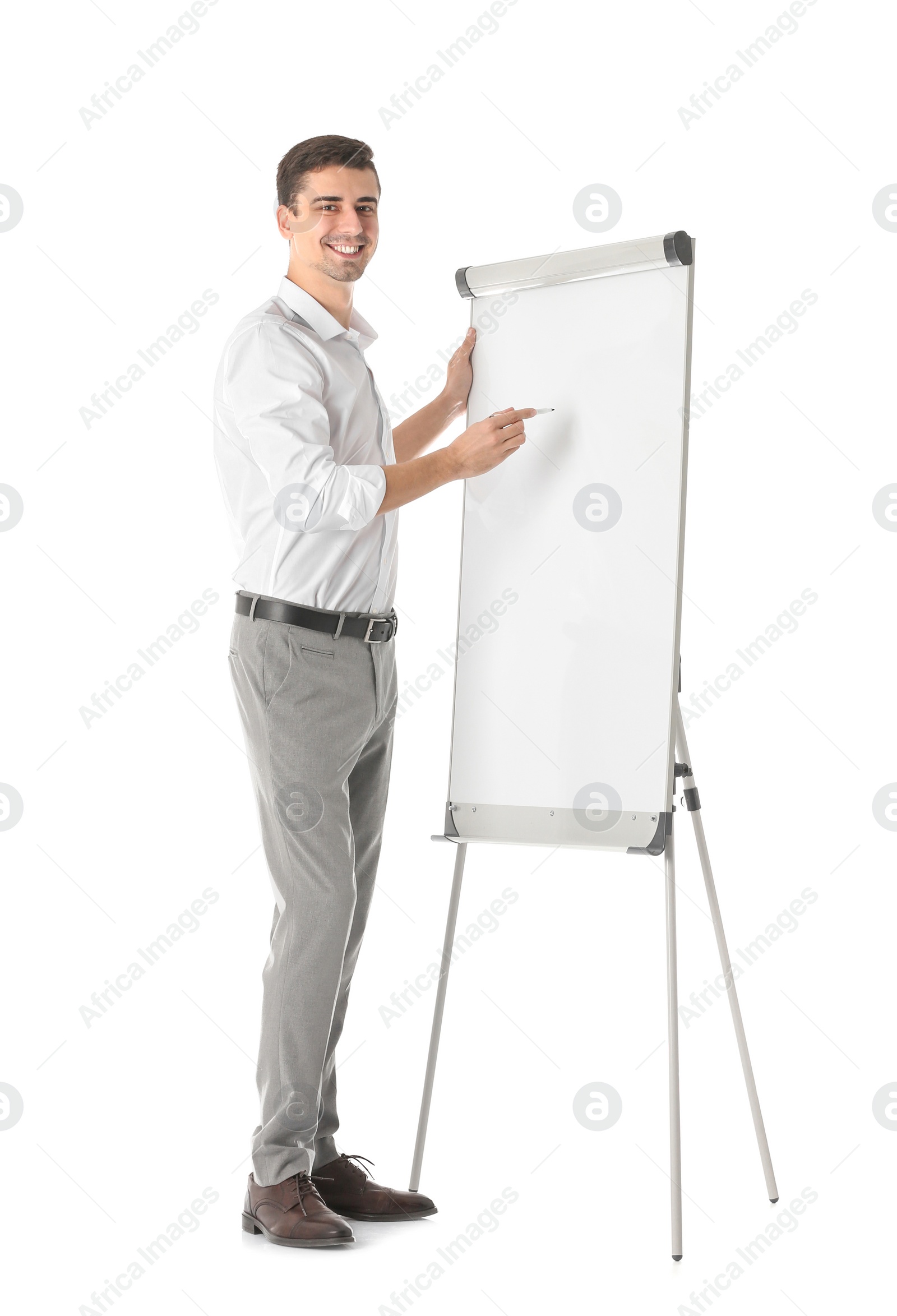 Business trainer giving presentation on flip chart board against white background Photo of Business trainer giving presentation on flip chart board against white background