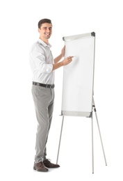 Business trainer giving presentation on flip chart board against white background Photo of Business trainer giving presentation on flip chart board against white background
