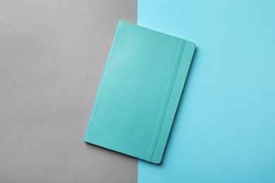 New stylish planner with hard cover on color background, top view Photo of New stylish planner with hard cover on color background, top view