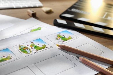 Storyboards with cartoon sketches at workplace, closeup. Pre-production process Photo of Storyboards with cartoon sketches at workplace, closeup. Pre-production process