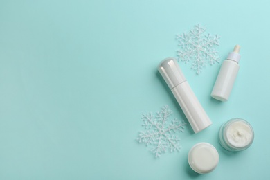 Flat lay composition with different cosmetic products on turquoise background, space for text. Winter care Photo of Flat lay composition with different cosmetic products on turquoise background, space for text. Winter care