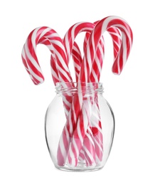 Glass with sweet Christmas candy canes on white background Photo of Glass with sweet Christmas candy canes on white background