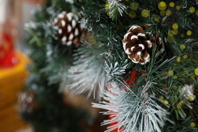 Fir tree branches with cones, closeup view. Christmas decor Photo of Fir tree branches with cones, closeup view. Christmas decor