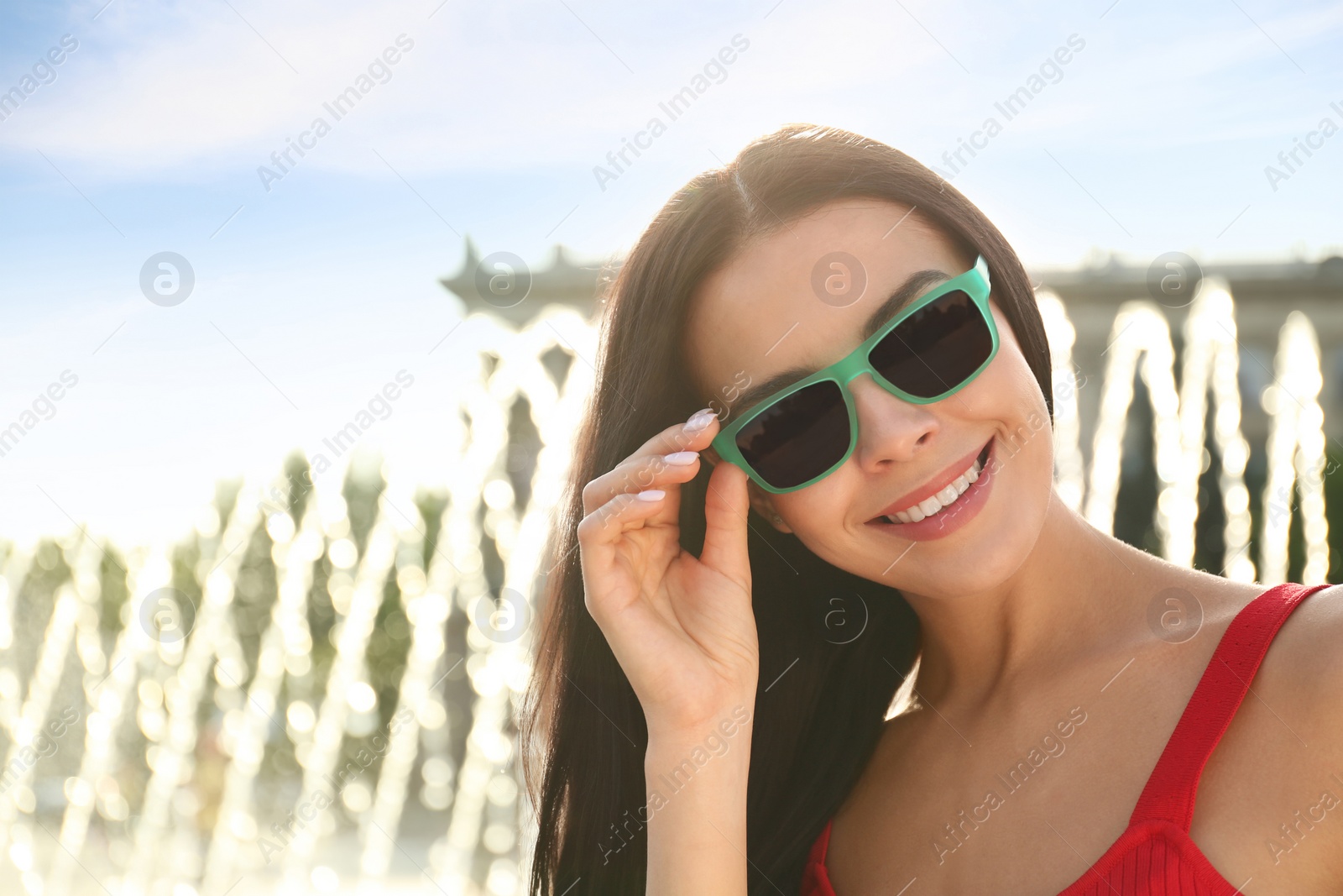 Beautiful young woman wearing stylish sunglasses outdoors. Space for text Photo of Beautiful young woman wearing stylish sunglasses outdoors. Space for text