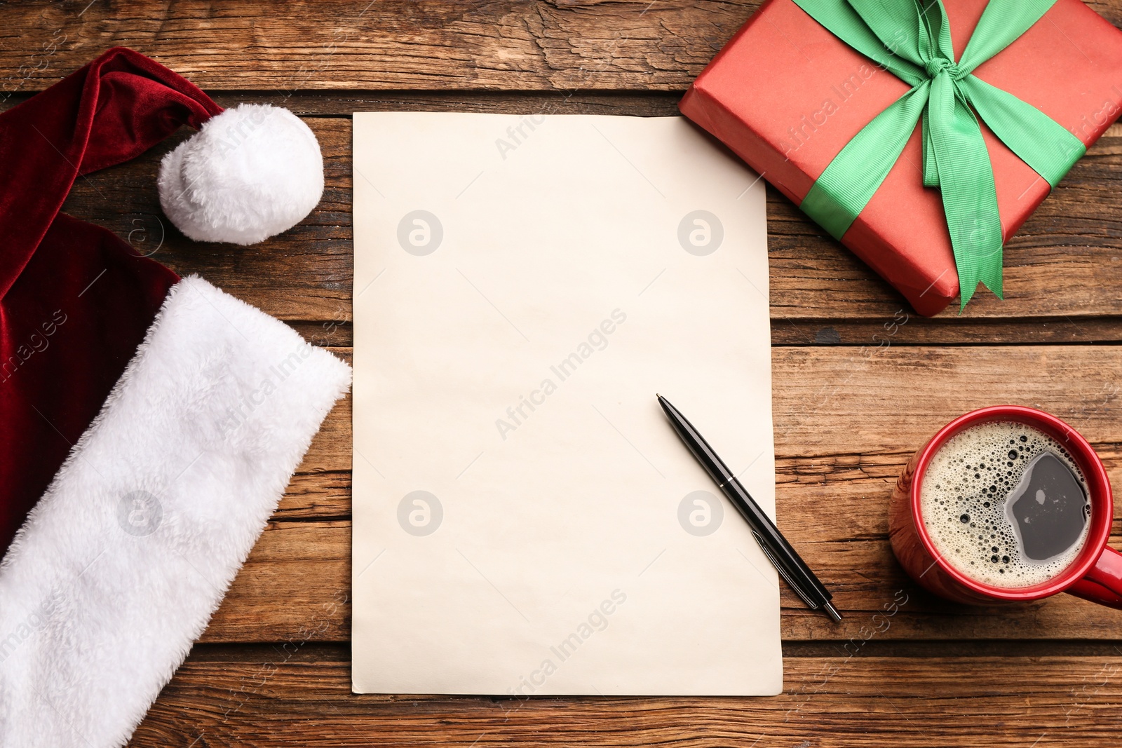 Flat lay composition with blank sheet of paper on wooden table, space for text. Writing letter to Santa Photo of Flat lay composition with blank sheet of paper on wooden table, space for text. Writing letter to Santa
