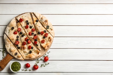 Flat lay composition with focaccia bread on white wooden table. Space for text Photo of Flat lay composition with focaccia bread on white wooden table. Space for text