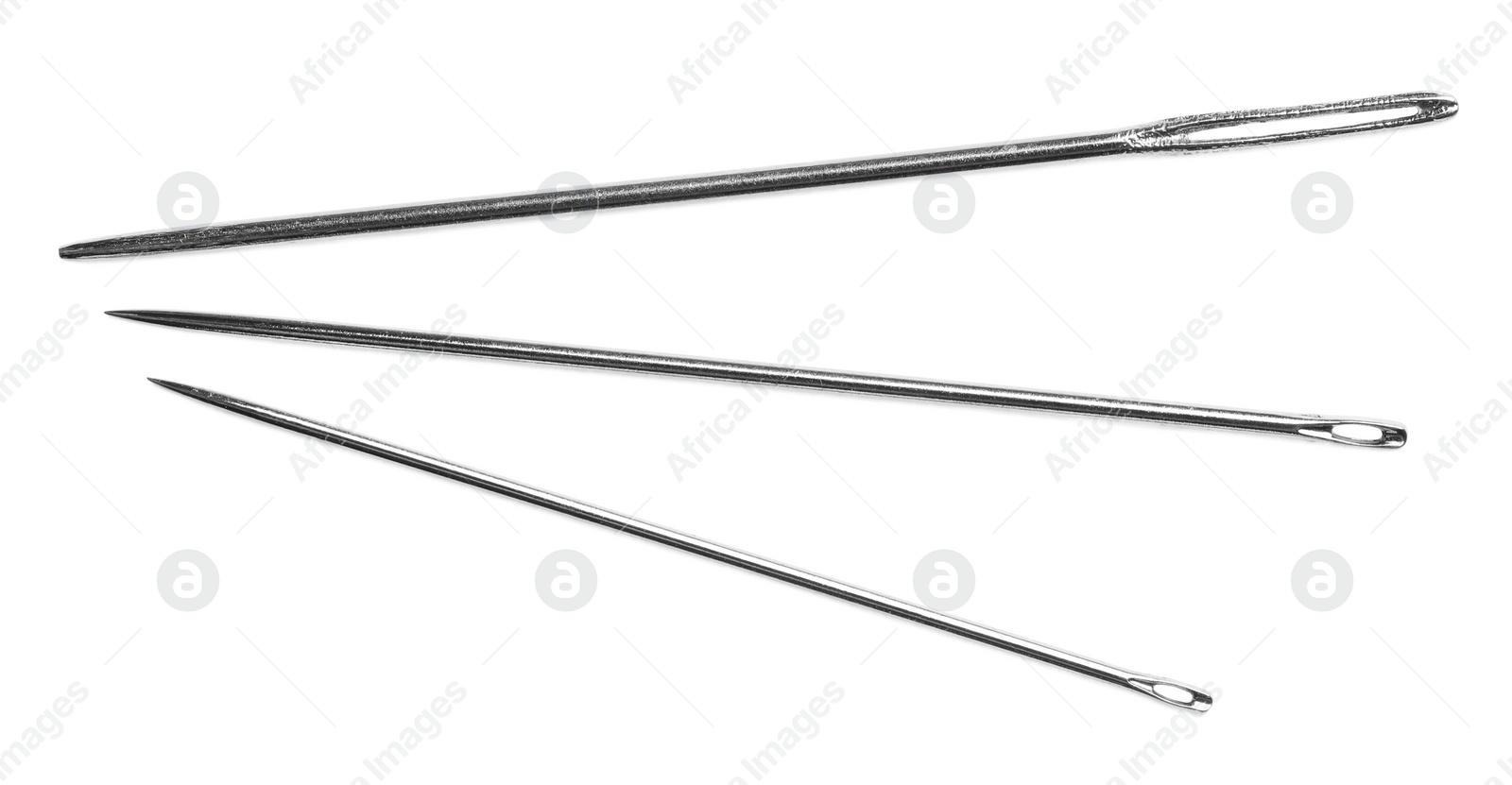 Photo of Set of sewing needles isolated on white, top view