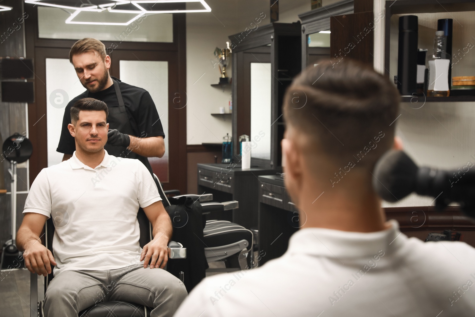 Professional hairdresser making stylish haircut in salon Photo of Professional hairdresser making stylish haircut in salon