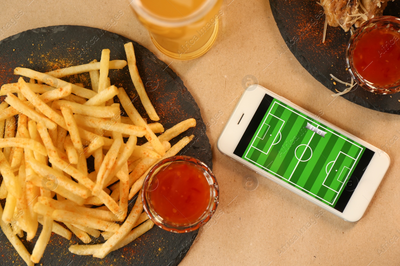 Flat lay composition with smartphone and french fries on table Photo of Flat lay composition with smartphone and french fries on table