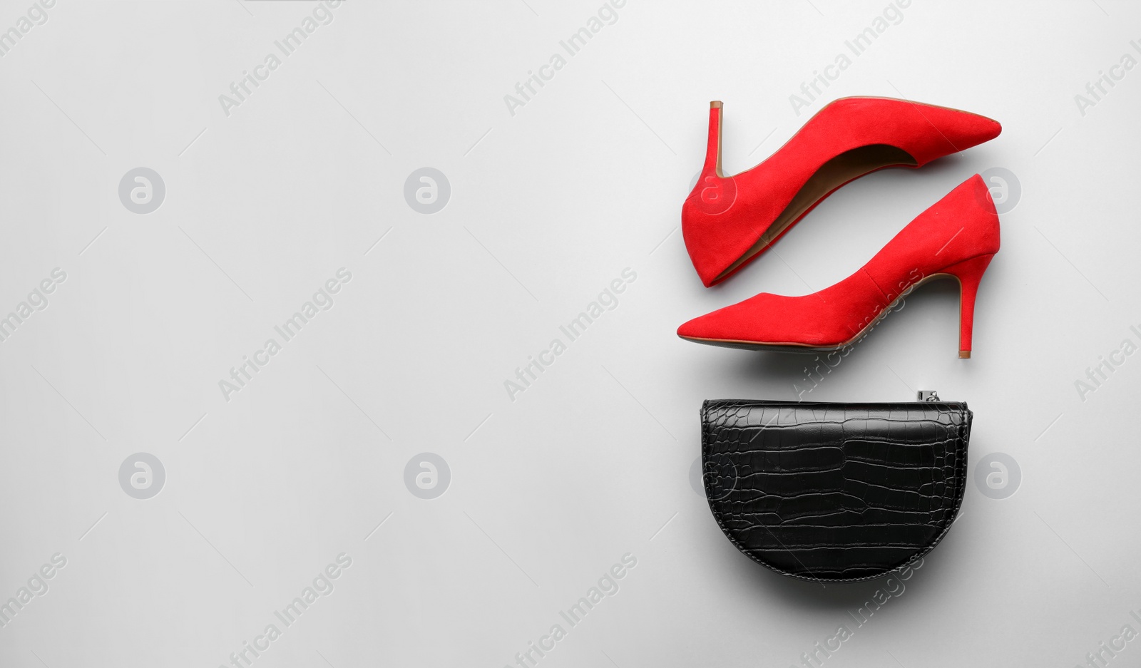 Stylish woman's bag and shoes on light background, flat lay Photo of Stylish woman's bag and shoes on light background, flat lay