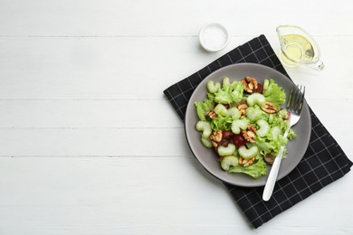 Delicious fresh celery salad served on white wooden table, flat lay. Space for text Photo of Delicious fresh celery salad served on white wooden table, flat lay. Space for text