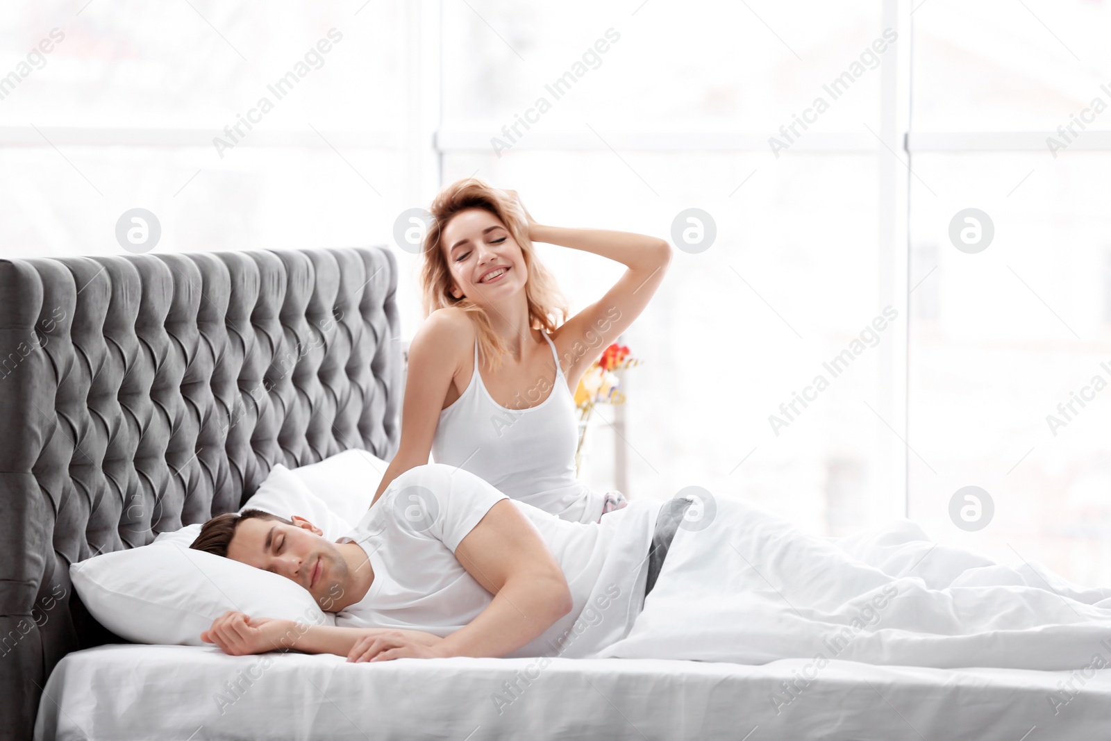 Happy young couple waking up at home Photo of Happy young couple waking up at home