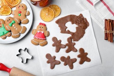 Flat lay composition with homemade gingerbread man cookies on light table Photo of Flat lay composition with homemade gingerbread man cookies on light table