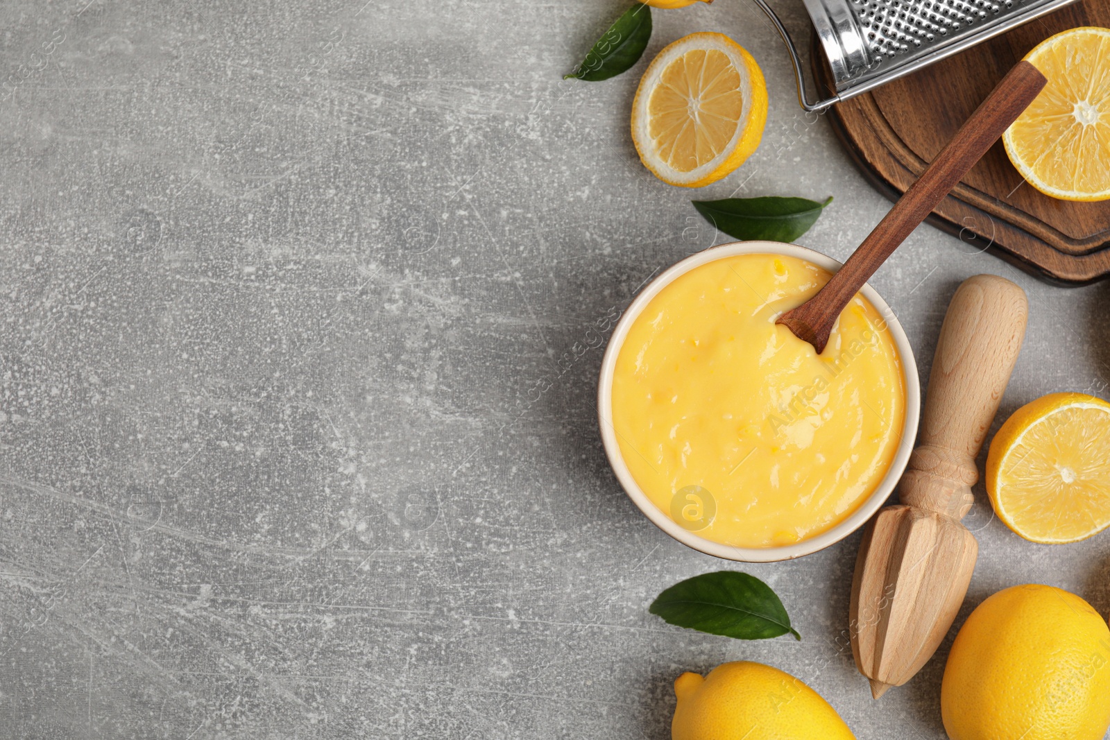 Delicious lemon curd and fresh fruits on light grey table, flat lay. Space for text Photo of Delicious lemon curd and fresh fruits on light grey table, flat lay. Space for text