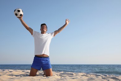 Man with football ball on beach. Space for text Photo of Man with football ball on beach. Space for text