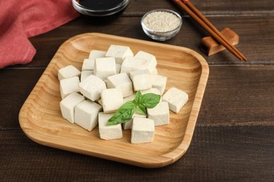 Delicious tofu with basil served on wooden table Photo of Delicious tofu with basil served on wooden table