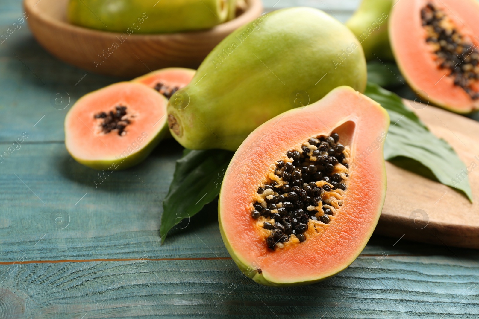 Fresh ripe papaya fruits on wooden table. Space for text Photo of Fresh ripe papaya fruits on wooden table. Space for text