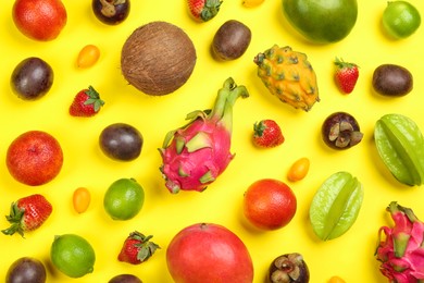 Assortment of fresh exotic fruits on yellow background, flat lay Photo of Assortment of fresh exotic fruits on yellow background, flat lay