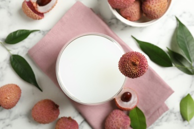 Fresh lychee juice and fruits on white marble table, flat lay Photo of Fresh lychee juice and fruits on white marble table, flat lay