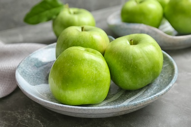 Plate with fresh green apples on table, closeup Photo of Plate with fresh green apples on table, closeup