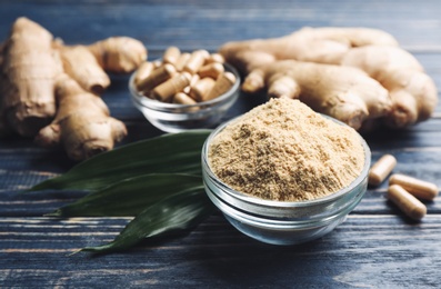 Dry, fresh and capsuled ginger on blue wooden table Photo of Dry, fresh and capsuled ginger on blue wooden table