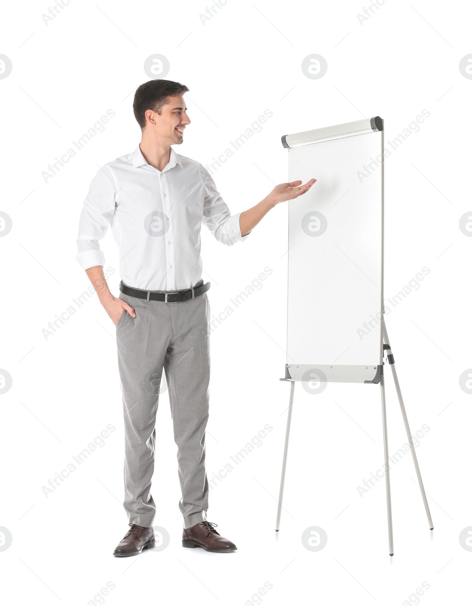 Business trainer giving presentation on flip chart board against white background Photo of Business trainer giving presentation on flip chart board against white background