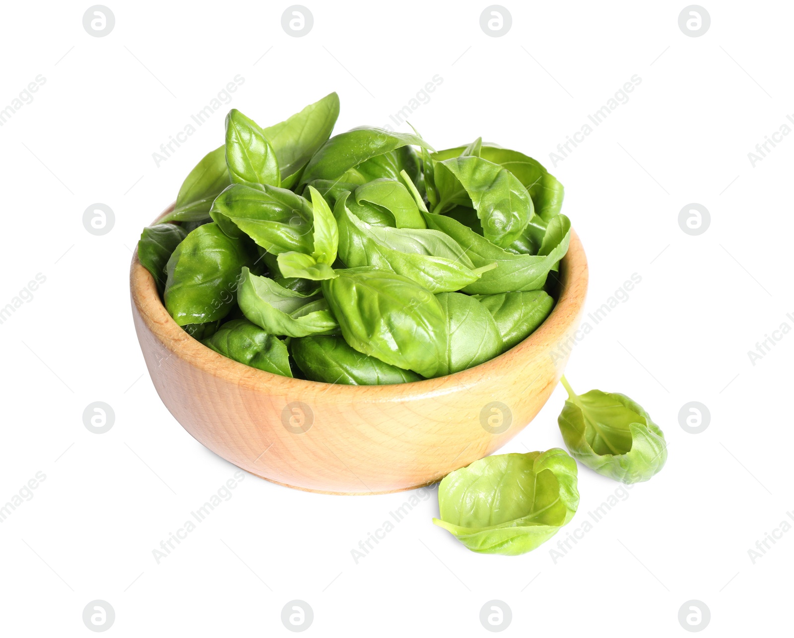 Photo of Fresh green basil leaves in wooden bowl isolated on white