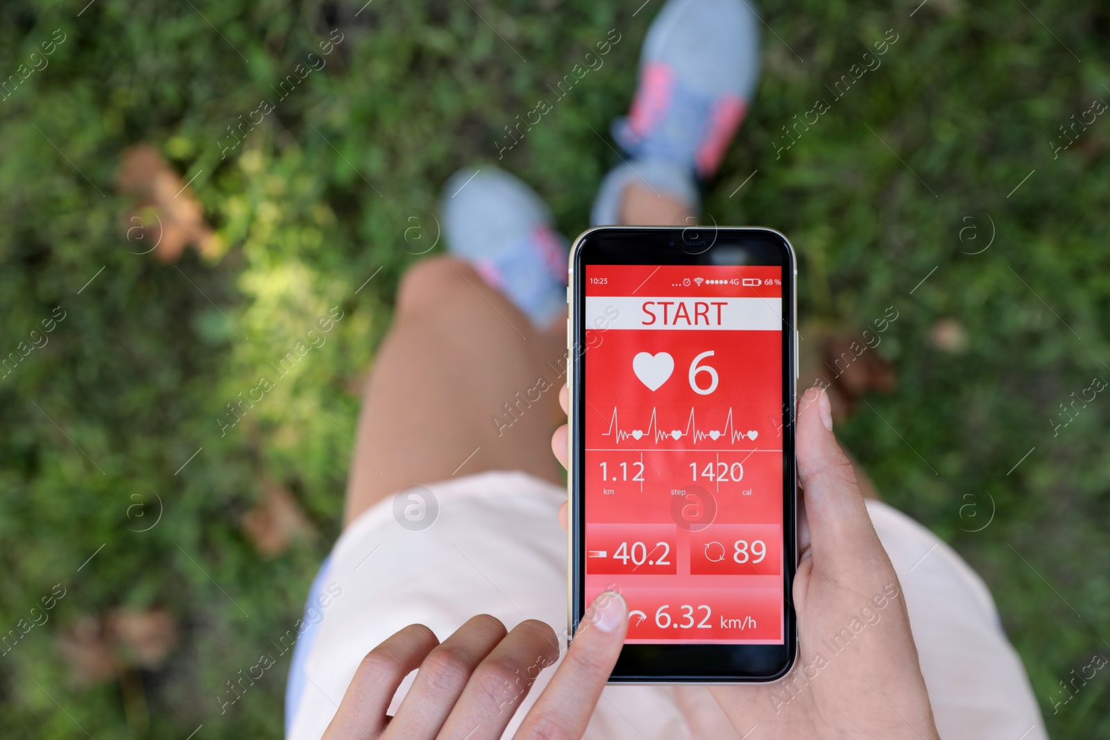 Young woman using fitness app on smartphone outdoors, top view Photo of Young woman using fitness app on smartphone outdoors, top view