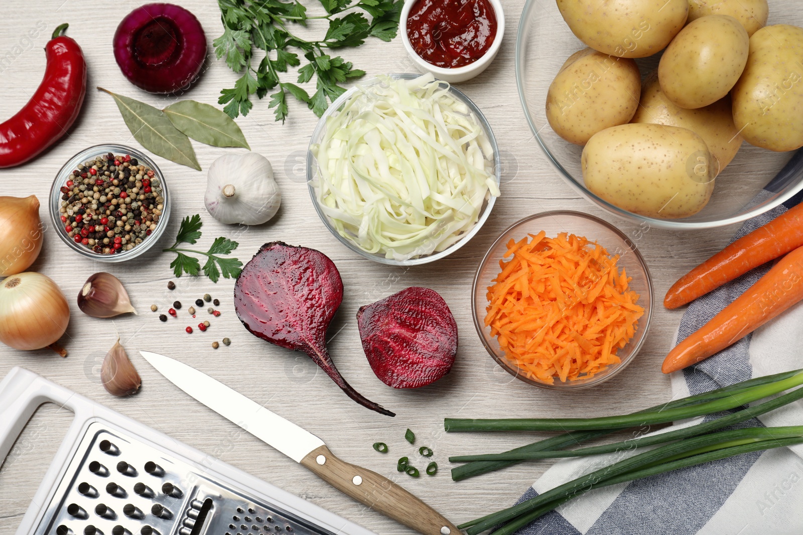 Fresh ingredients for borscht on white wooden table, flat lay Photo of Fresh ingredients for borscht on white wooden table, flat lay