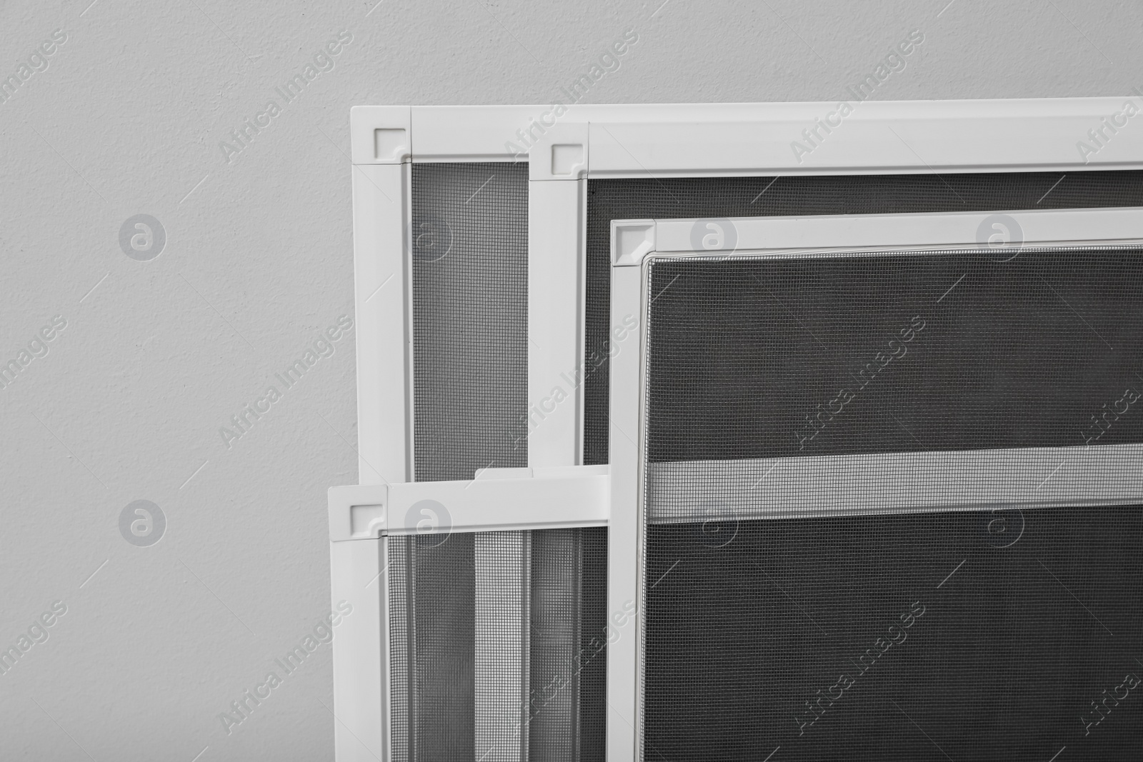 Set of window screens on light grey background, closeup Photo of Set of window screens on light grey background, closeup