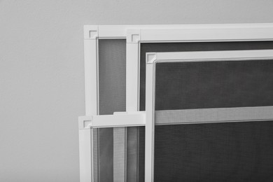 Set of window screens on light grey background, closeup Photo of Set of window screens on light grey background, closeup