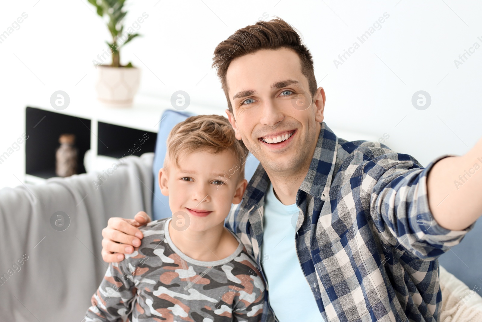 Dad and his son taking selfie at home Photo of Dad and his son taking selfie at home