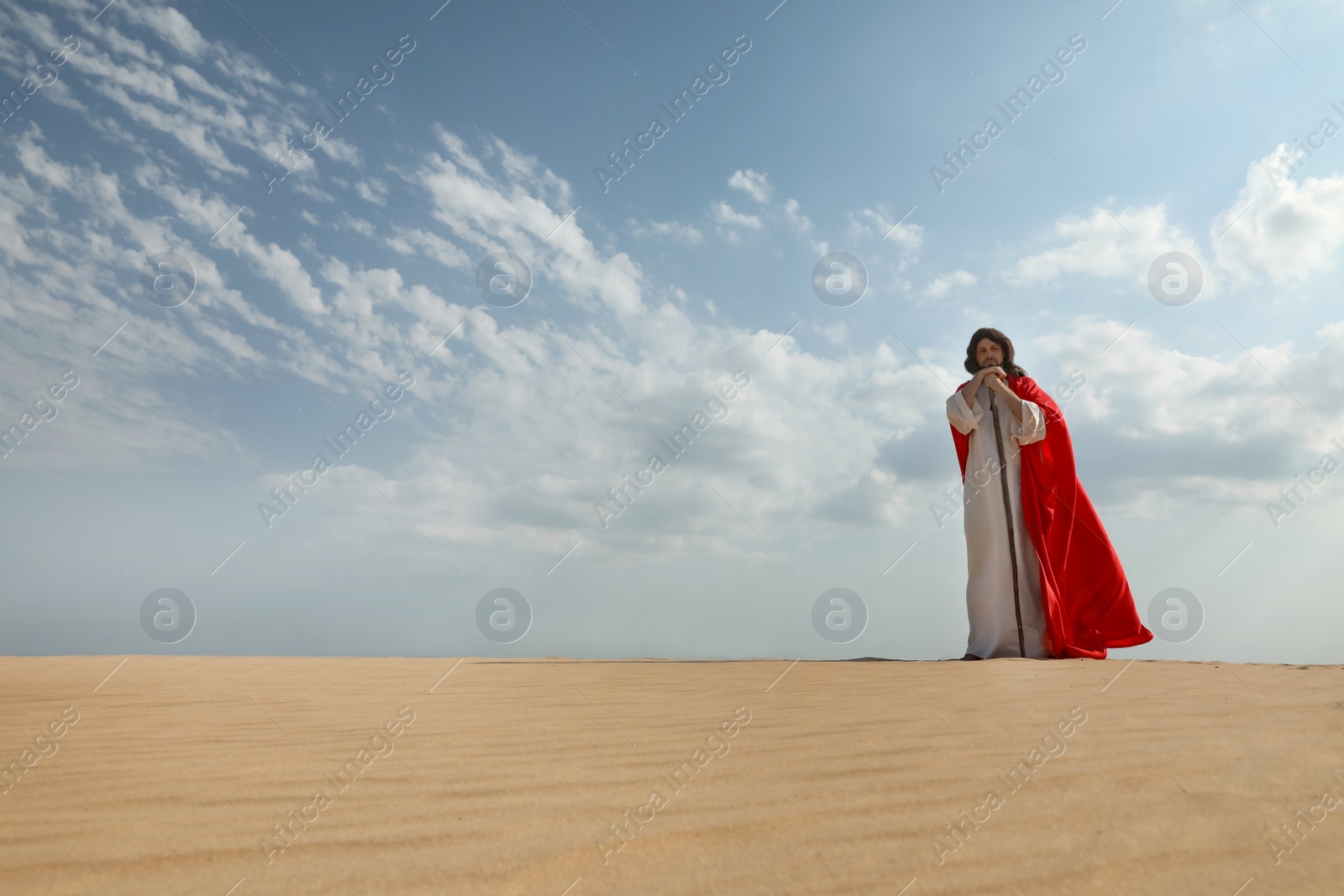 Jesus Christ walking with stick in desert. Space for text Photo of Jesus Christ walking with stick in desert. Space for text