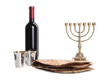 Photo of Tasty matzos, wine and menorah on white background. Passover (Pesach) celebration