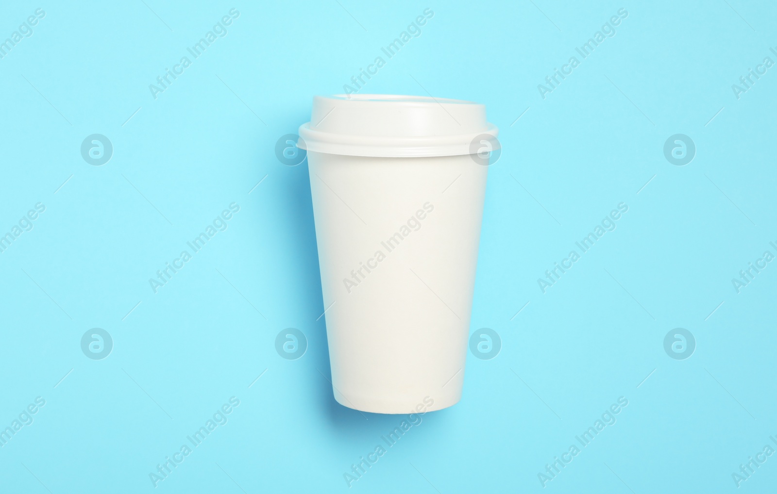 Takeaway paper coffee cup with on light blue background, top view Photo of Takeaway paper coffee cup with on light blue background, top view