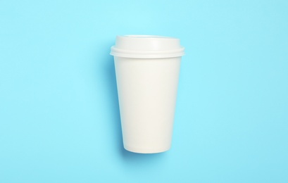 Takeaway paper coffee cup with on light blue background, top view Photo of Takeaway paper coffee cup with on light blue background, top view